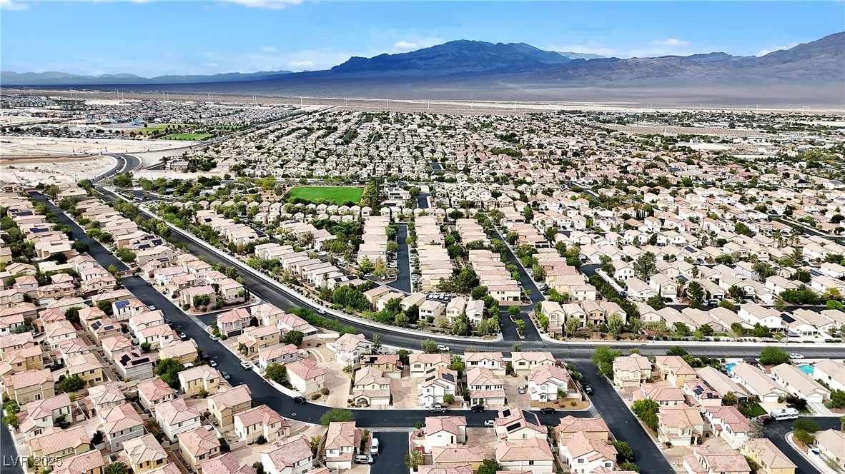 9065 Starling Wing Place Las Vegas, NV 89143 - Photo 38 of 53 Aerial overview of property's location with nearby suburban area and mountains