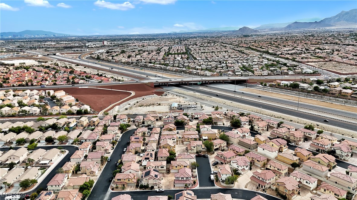 9065 Starling Wing Place Las Vegas, NV 89143 - Photo 40 of 53 Aerial view of property and surrounding area with nearby suburban area and mountains