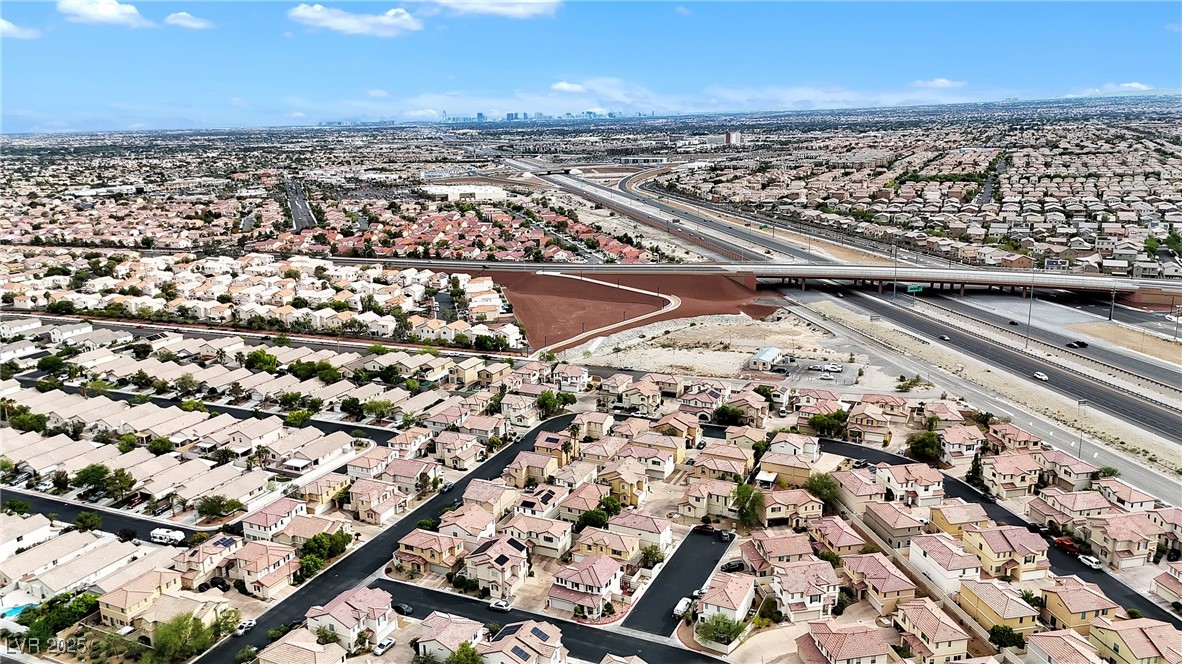 9065 Starling Wing Place Las Vegas, NV 89143 - Photo 42 of 53 Aerial view of property's location with a highway and nearby suburban area