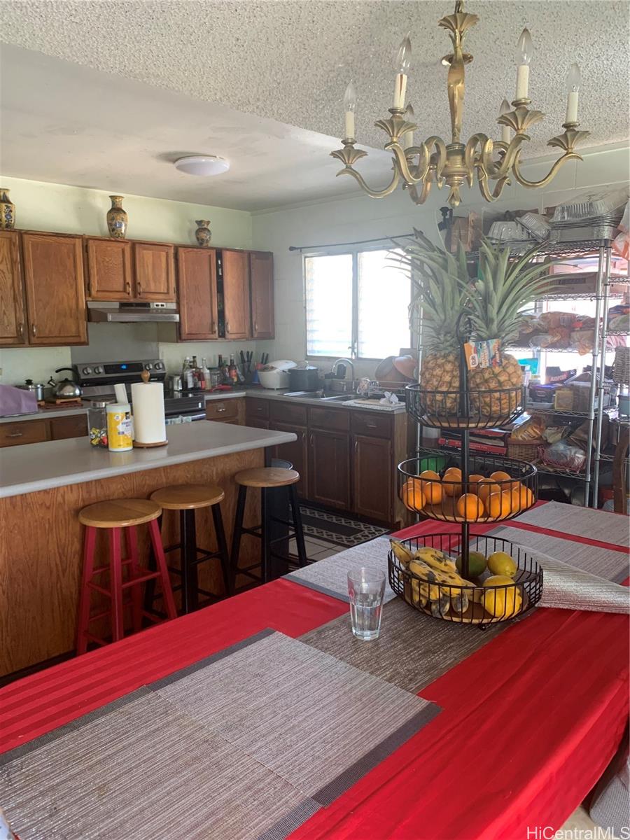 1829 Akone Place Honolulu, HI 96819 - Photo 2 of 2 a kitchen with stainless steel appliances granite countertop a stove refrigerator and cabinets