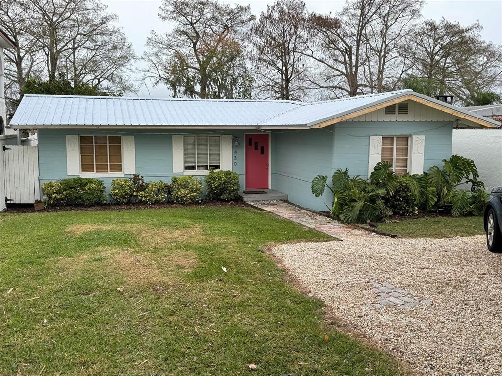 a front view of a house with a garden