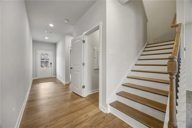 a view of entryway with wooden floor and stairs