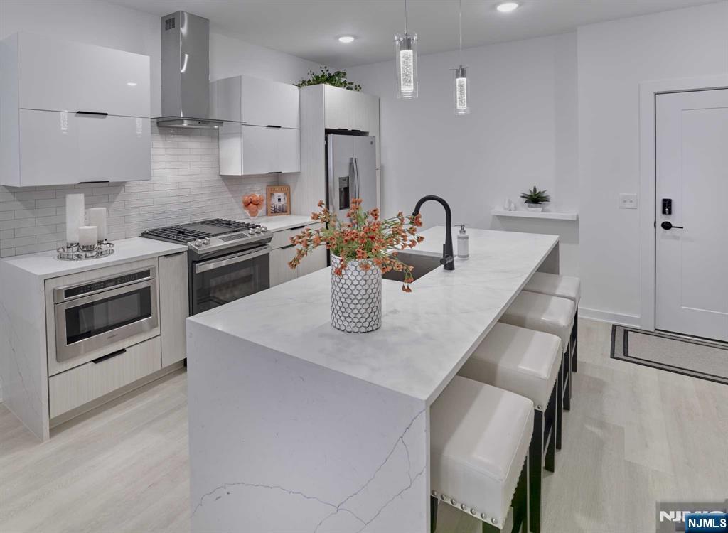 8 Tice Road, Unit 107 Franklin Lakes, NJ 07417 - Photo 4 of 29 a kitchen with stainless steel appliances granite countertop a sink a stove and a refrigerator