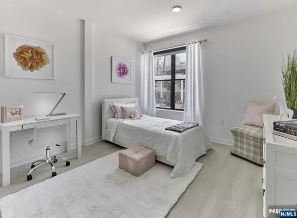 a spacious bedroom with a bed and a window