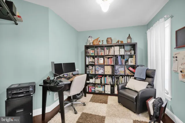a dining room with wooden floor a chandelier a wooden table and chairs