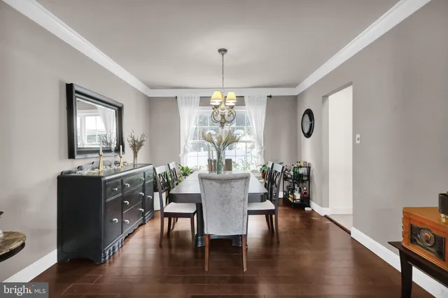 a kitchen with kitchen island granite countertop a dining table and chairs