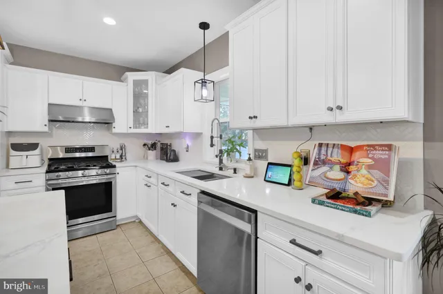 a kitchen with stainless steel appliances kitchen island granite countertop a sink and cabinets