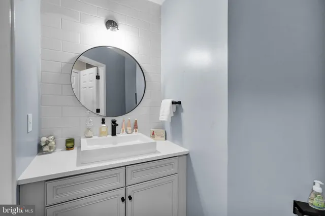 a bathroom with double vanity sink and a mirror