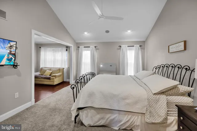 a bedroom with a large bed and a window