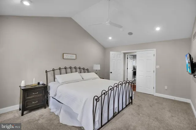 a bedroom with a bed and a ceiling fan