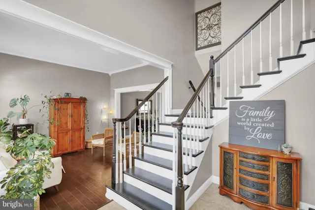 a view of an entryway with wooden floor and stairs