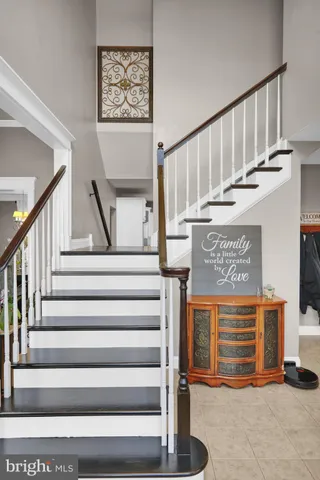 a view of an entryway with wooden floor and stairs