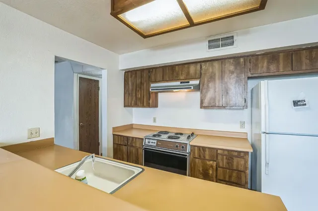 a kitchen with a stove and a refrigerator