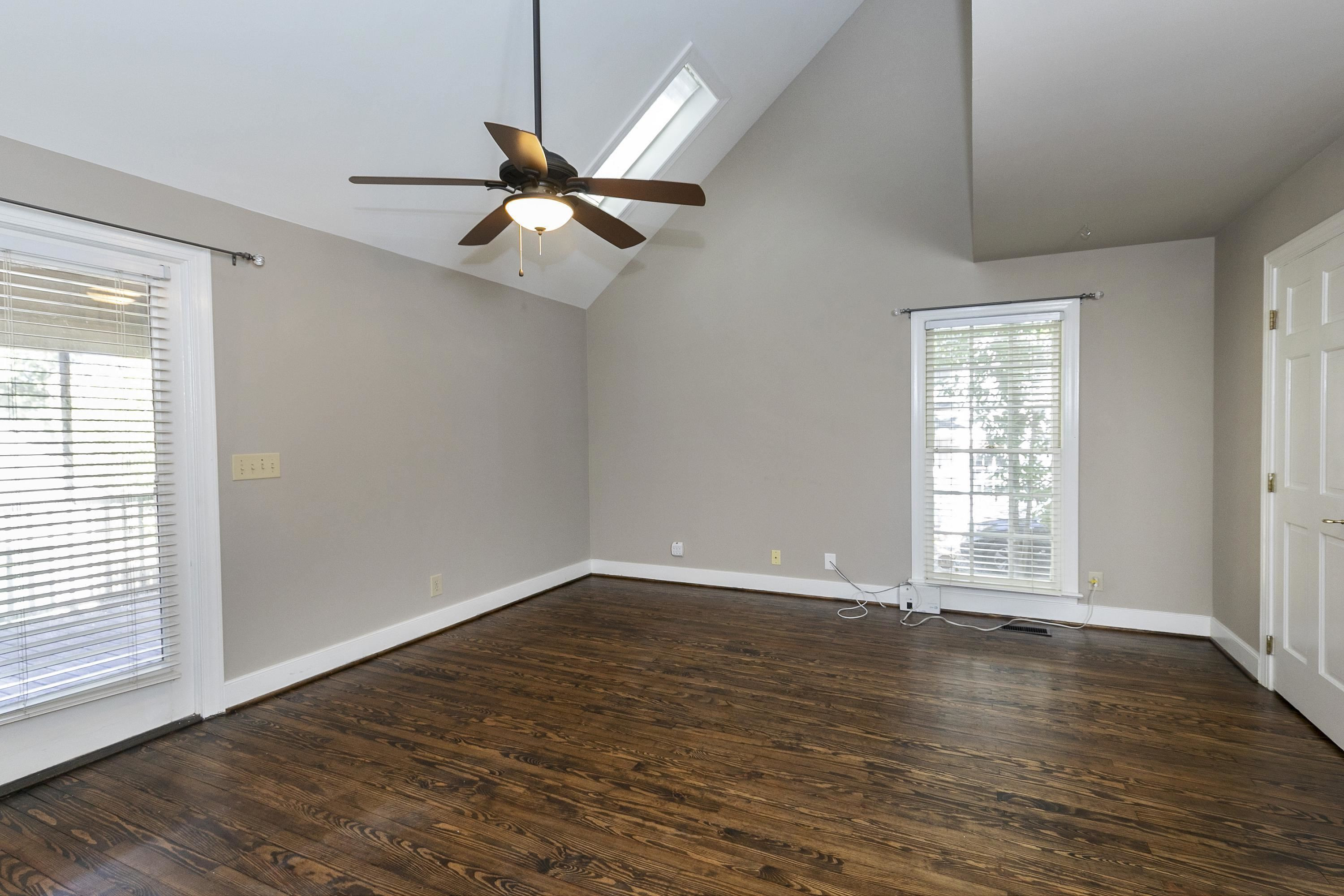 411 Dixie Trail Raleigh, NC 27607 - Photo 10 of 38 FIRST FLOOR Primary bedroom with large walk in closet, hardwood floors, spa bath & opens to screen porch MAIN FLOOR Primary bedroom