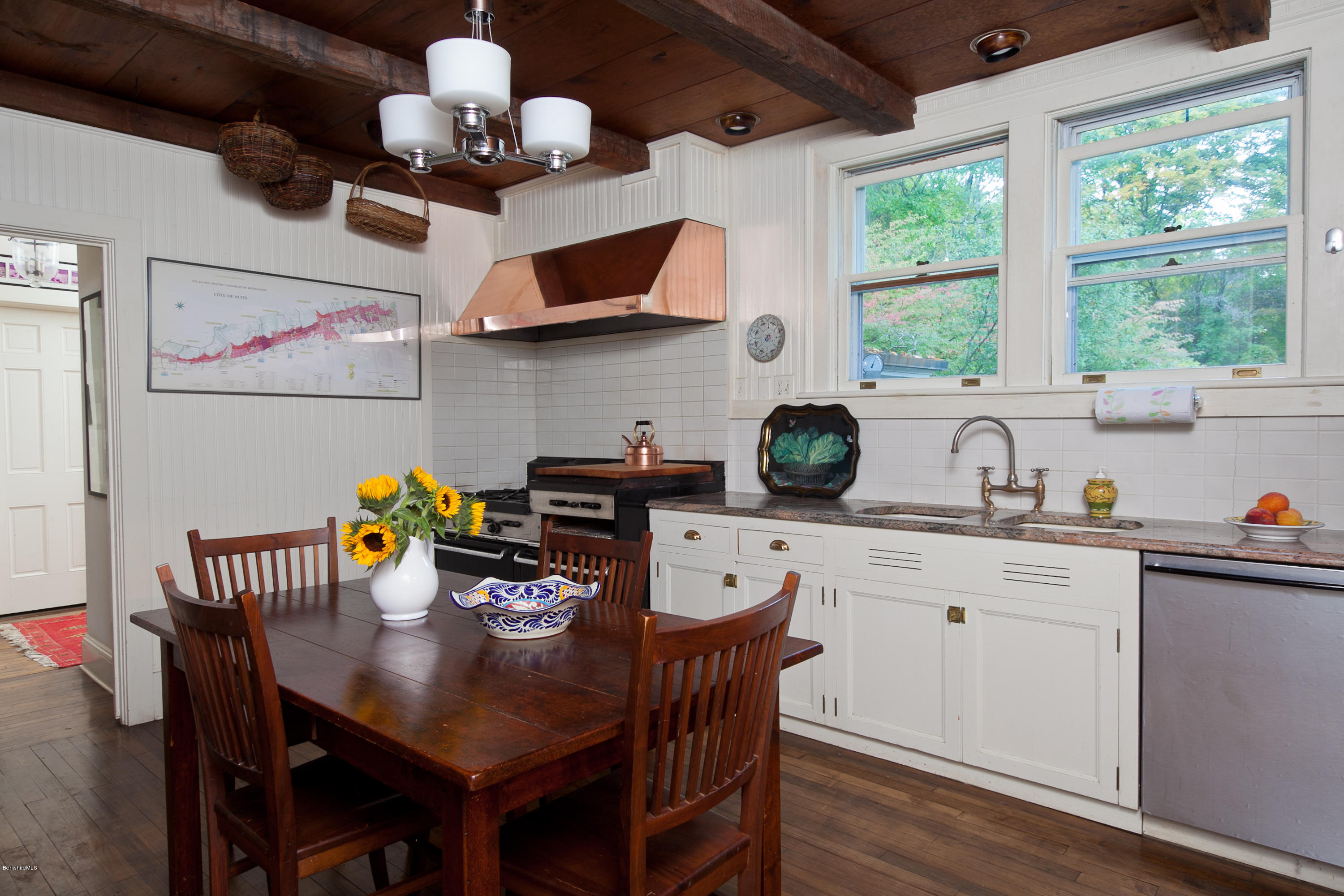 2 Brace Road Tyringham, MA 01264 - Photo 23 of 61 a kitchen with stainless steel appliances granite countertop a sink dishwasher a dining table and chairs with wooden floor