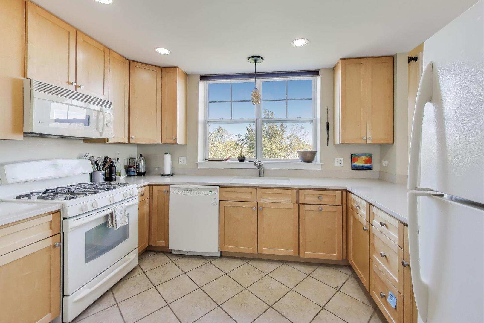 977 Harris Road, Unit 34 Grayslake, IL 60030 - Photo 6 of 27 a kitchen with granite countertop cabinets stainless steel appliances a sink and a window