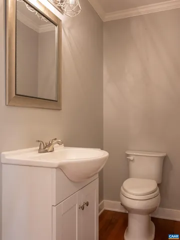 a bathroom with a sink a toilet and mirror