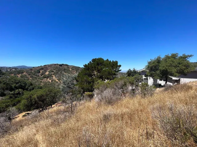 a view of a mountain range with trees in the background