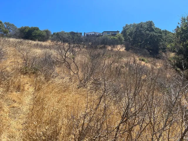 a view of mountain with sunset in background