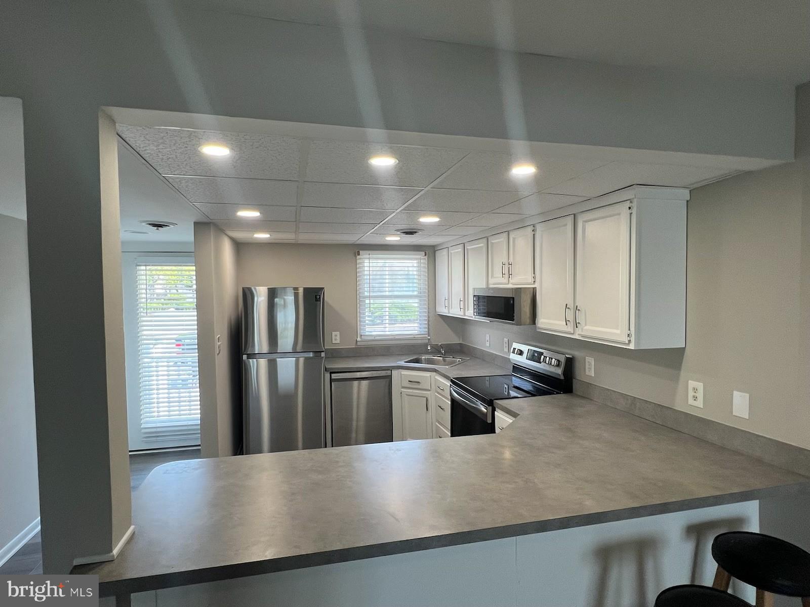 165 Jamestown Road Ocean City, MD 21842 - Photo 4 of 14 a view of large kitchen with kitchen island a sink stainless steel appliances and cabinets