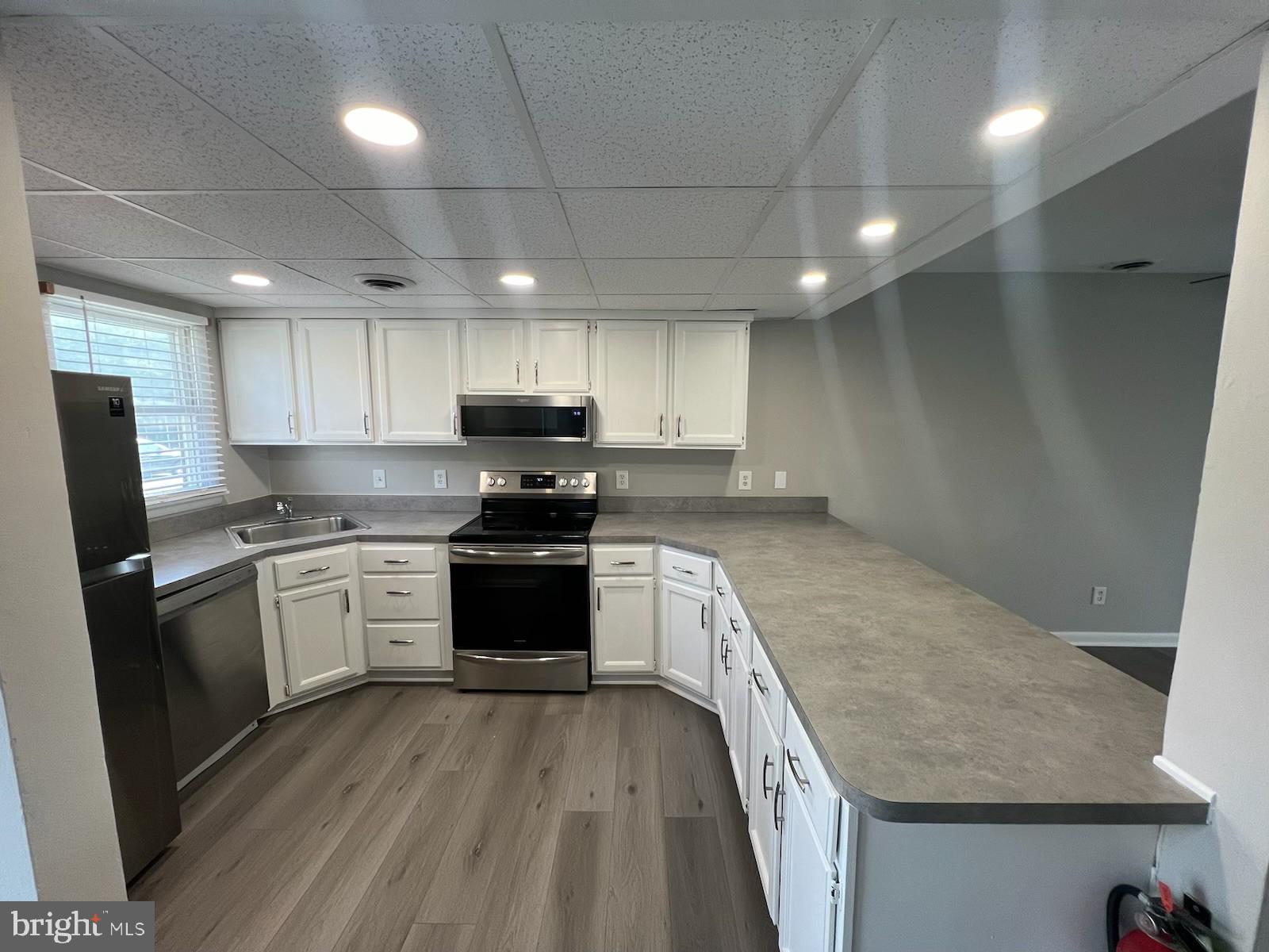 165 Jamestown Road Ocean City, MD 21842 - Photo 5 of 14 a kitchen with granite countertop a sink stainless steel appliances and cabinets