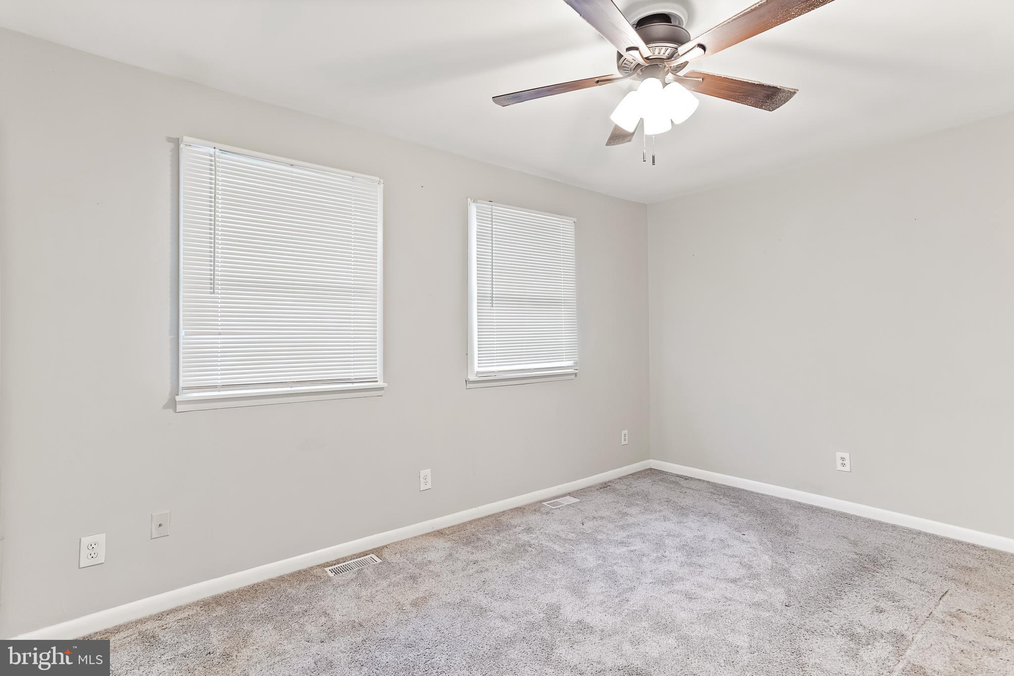 165 Jamestown Road Ocean City, MD 21842 - Photo 8 of 14 an empty room with a window and a fan
