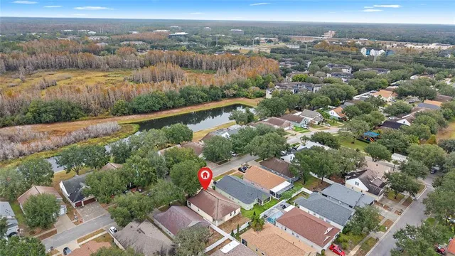 an aerial view of residential houses with outdoor space and trees