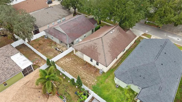 an aerial view of residential houses with outdoor space and lake view