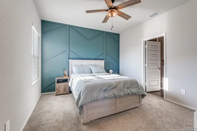 a bedroom with a bed and window