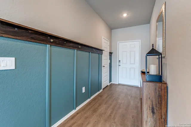 a view of hallway with wooden floor