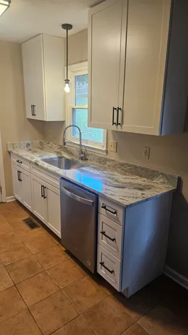 a sink with granite countertop a sink and cabinets