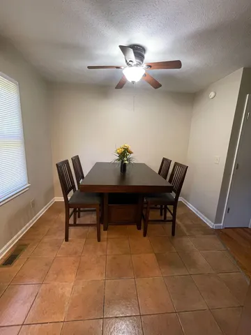 a dining room with a table and chairs