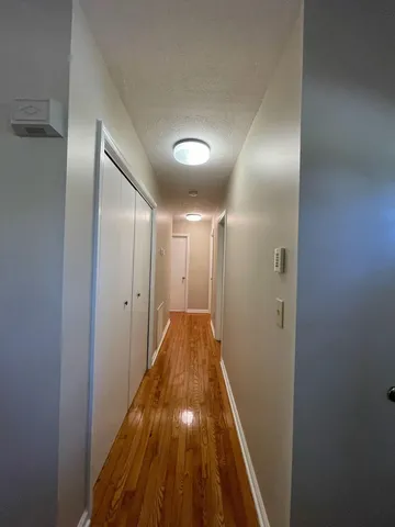 a view of hallway with wooden floor