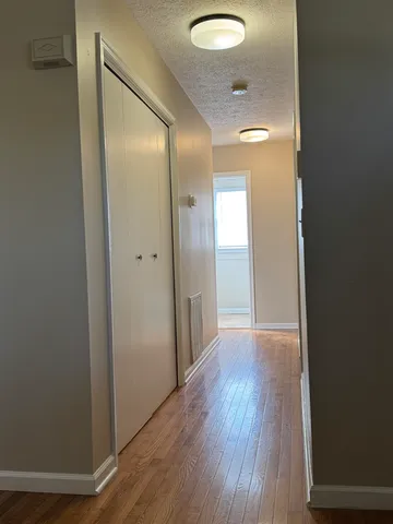 a view of a hallway with wooden floor