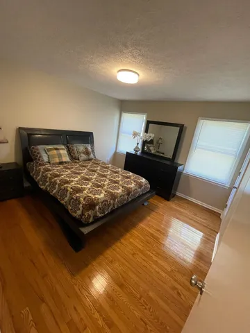 a bedroom with a bed and window