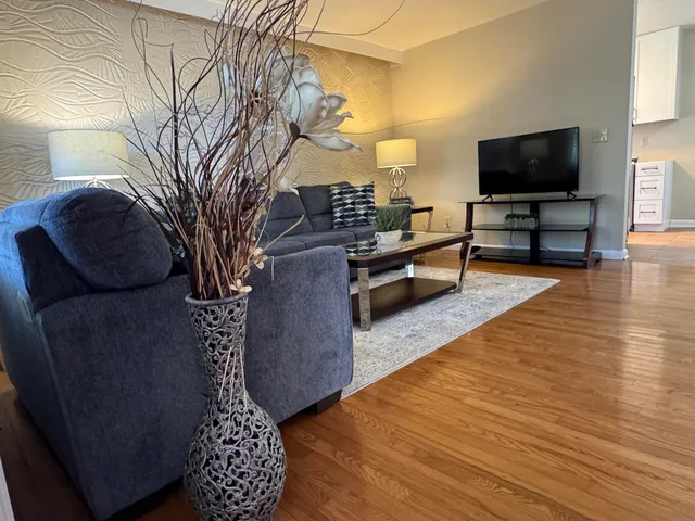 a living room with furniture and a flat screen tv