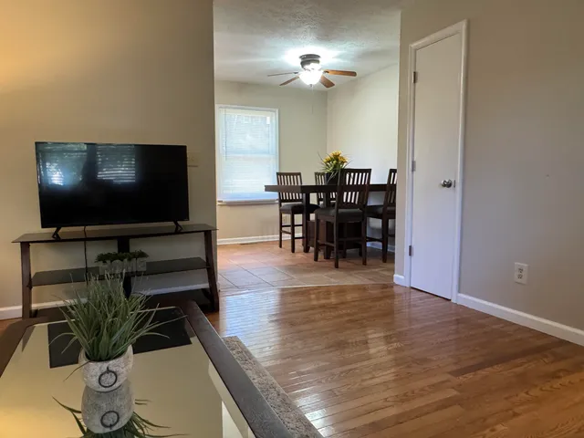 a view of a livingroom with furniture and a flat screen tv