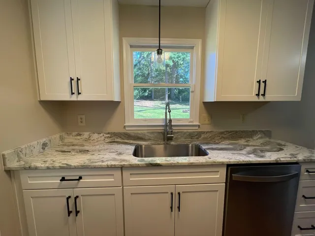 a kitchen with appliances cabinets and a sink
