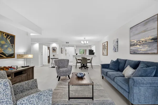 a spacious bedroom with a bed a couch and a window