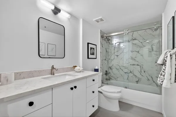 an aerial view of residential house with outdoor space and trees all around