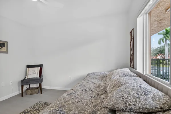 an aerial view of a swimming pool with lawn chairs and plants
