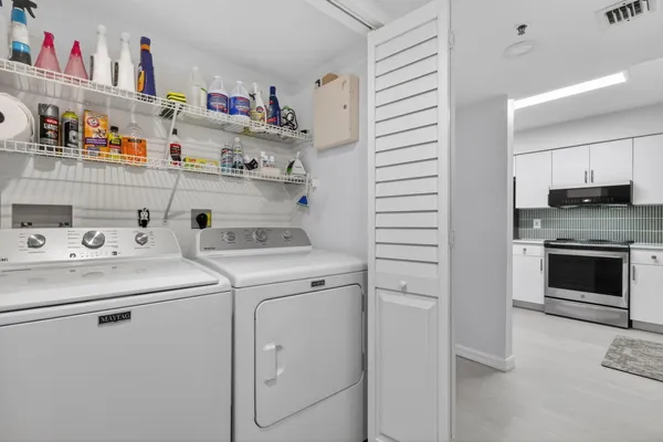 a open kitchen with stainless steel appliances granite countertop a stove a sink and a refrigerator