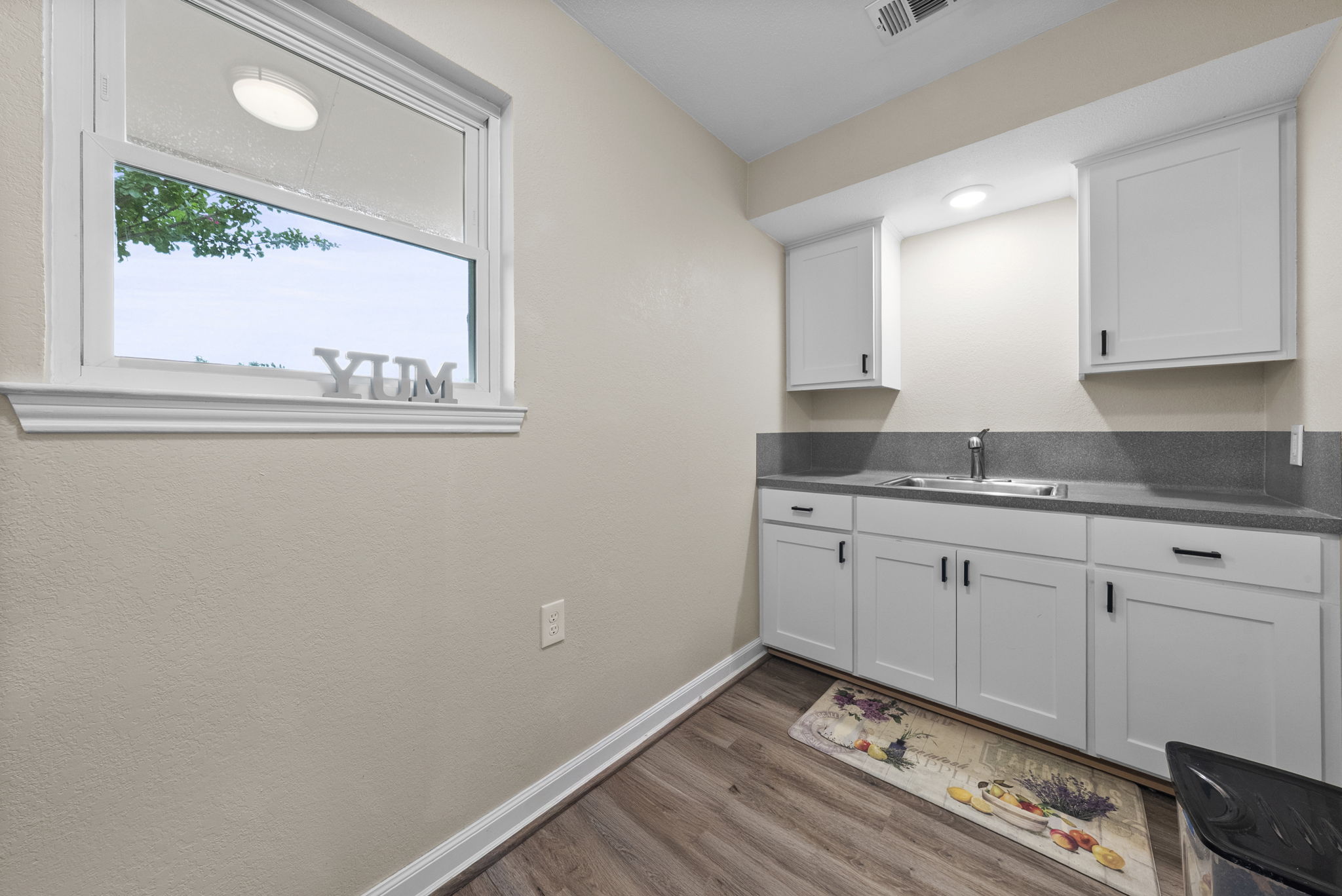 2702 Double Tree Street Round Rock, TX 78681 - Photo 21 of 40 a view of kitchen with granite countertop cabinets and window