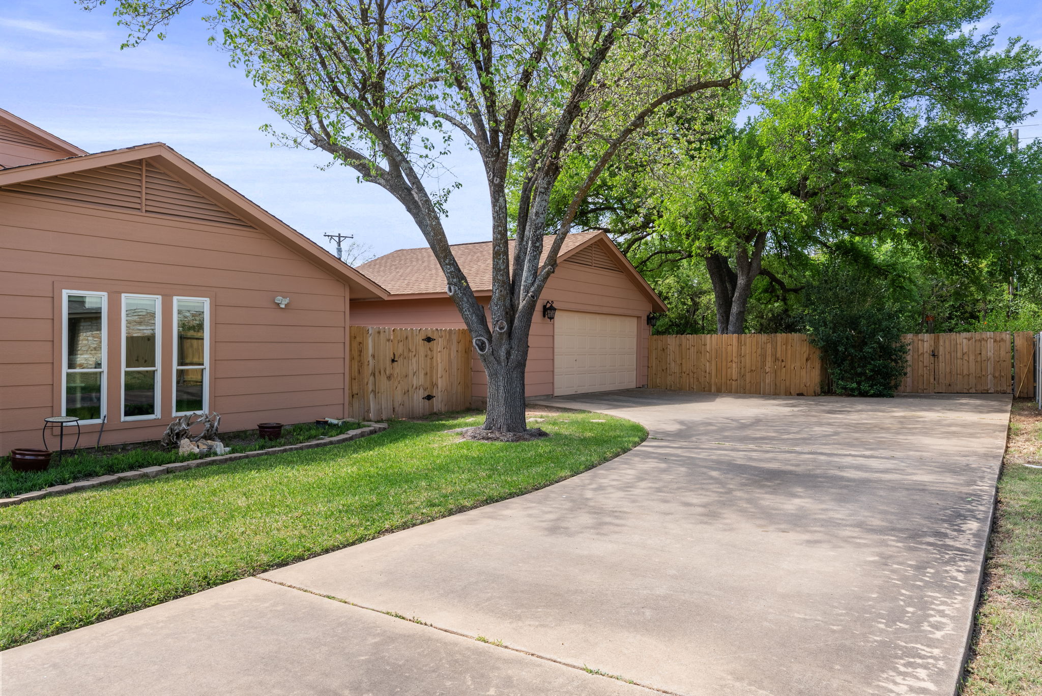 2702 Double Tree Street Round Rock, TX 78681 - Photo 38 of 40 a view of a backyard with large trees and wooden fence