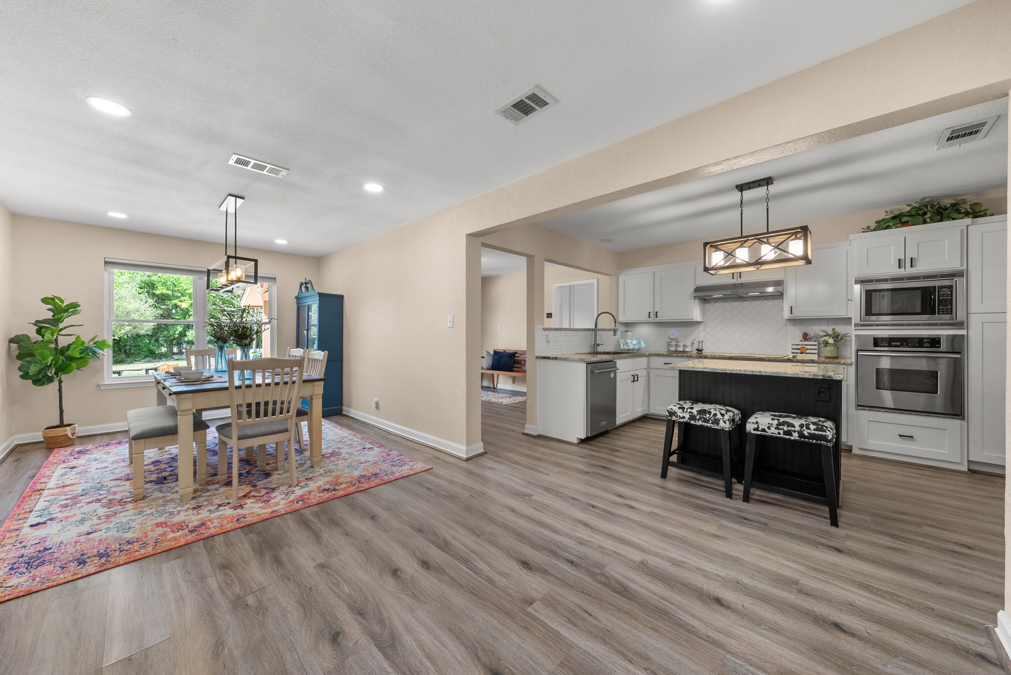 2702 Double Tree Street Round Rock, TX 78681 - Photo 5 of 40 a kitchen with stainless steel appliances kitchen island granite countertop a table chairs and a refrigerator