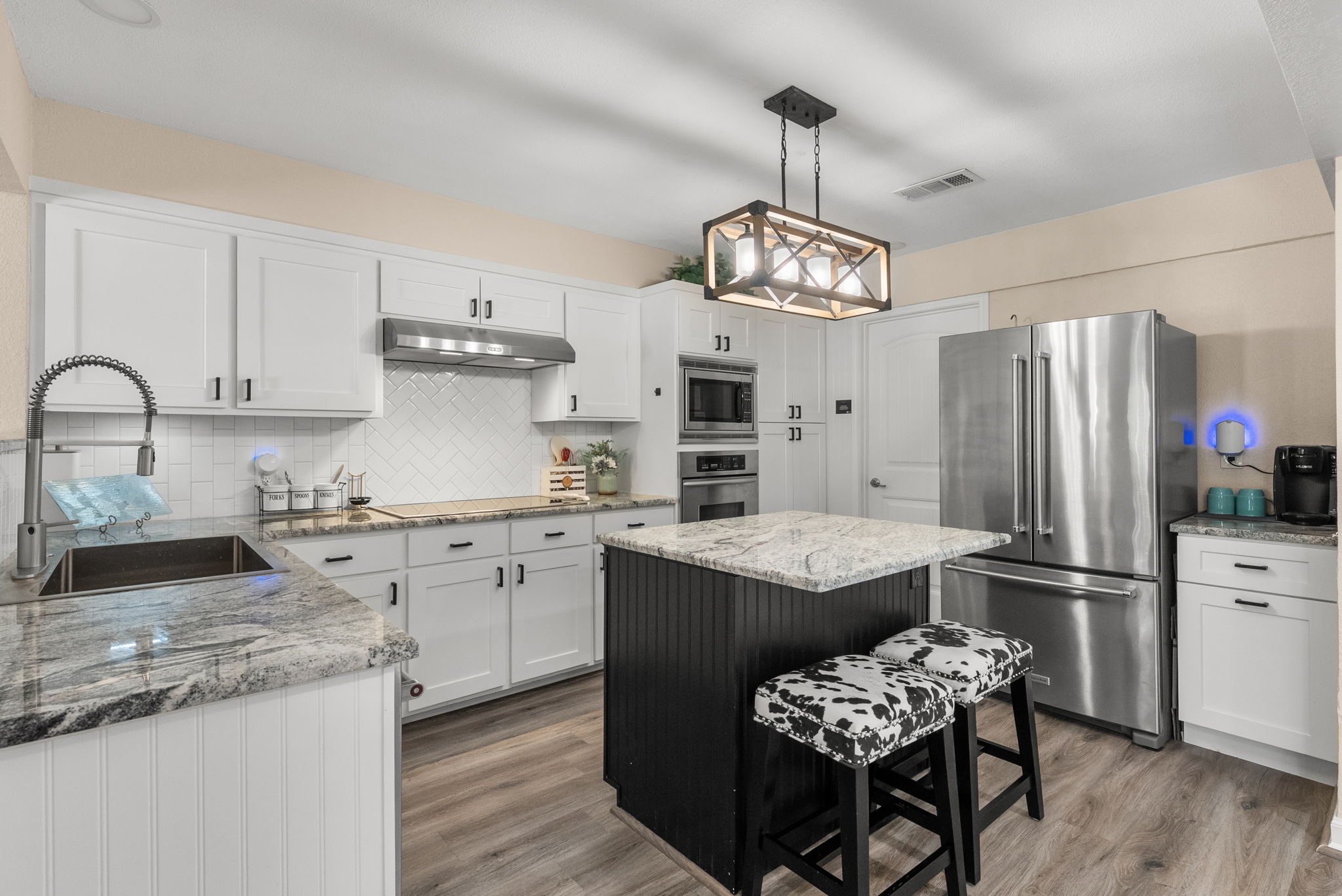 2702 Double Tree Street Round Rock, TX 78681 - Photo 6 of 40 a kitchen with granite countertop stainless steel appliances a sink stove and refrigerator