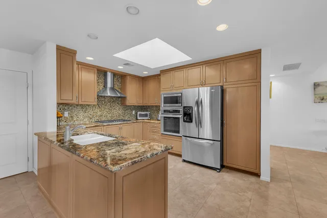 a kitchen with a refrigerator a microwave and sink