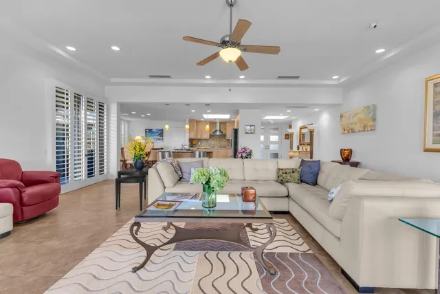 a living room with furniture and kitchen view