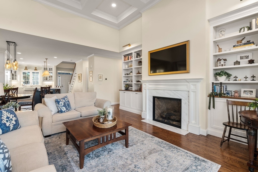 22 Sunset Way, Unit 22 Medfield, MA 02052 - Photo 13 of 42 a living room with furniture a flat screen tv and a fireplace