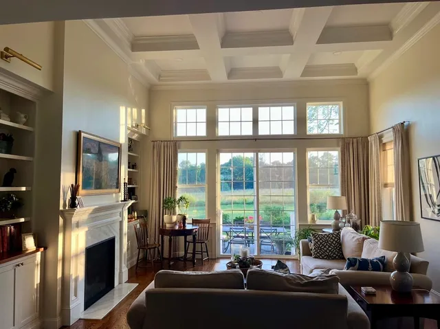 a living room with furniture and floor to ceiling windows